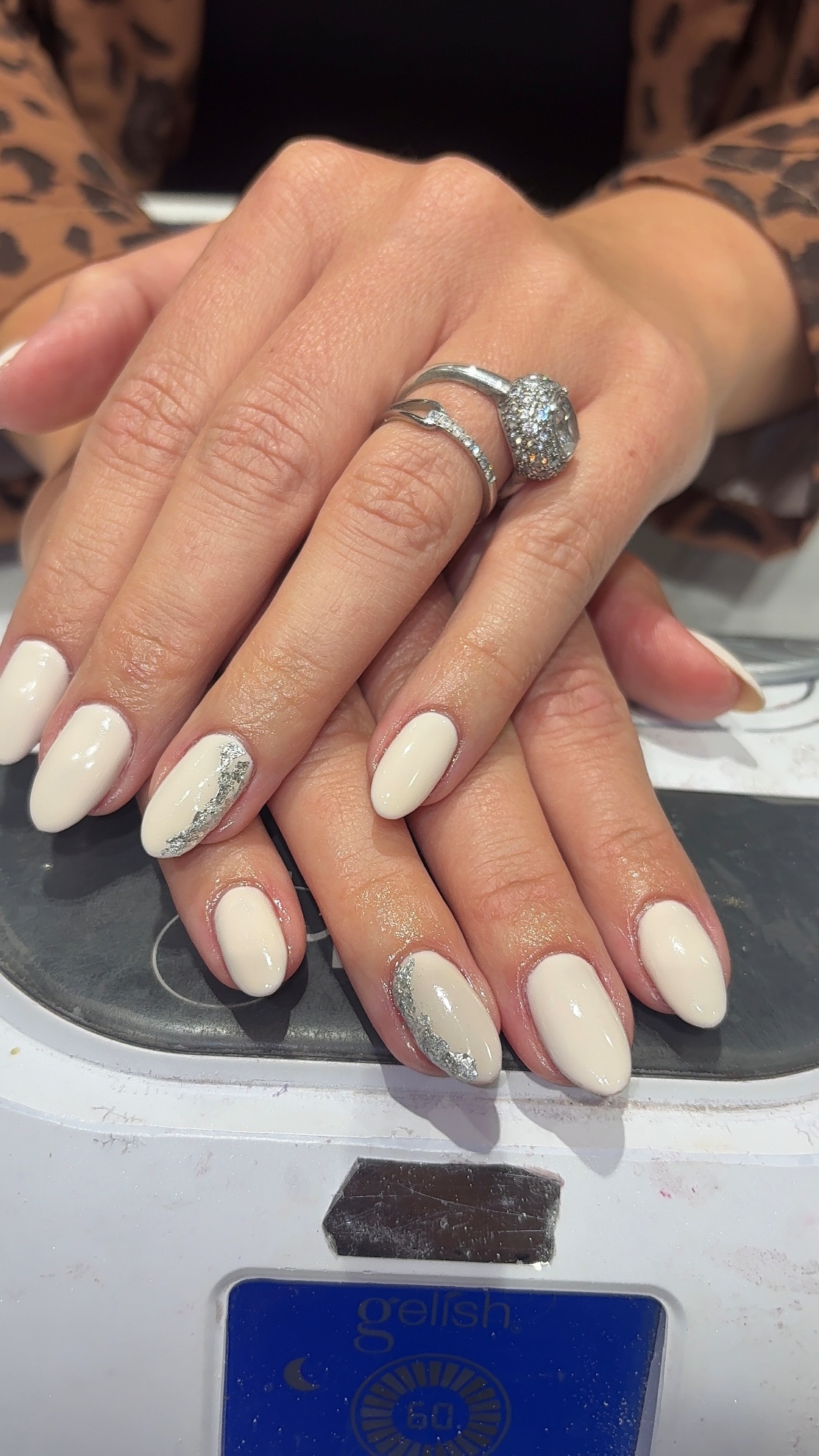Nude gel nails with silver glitter accent